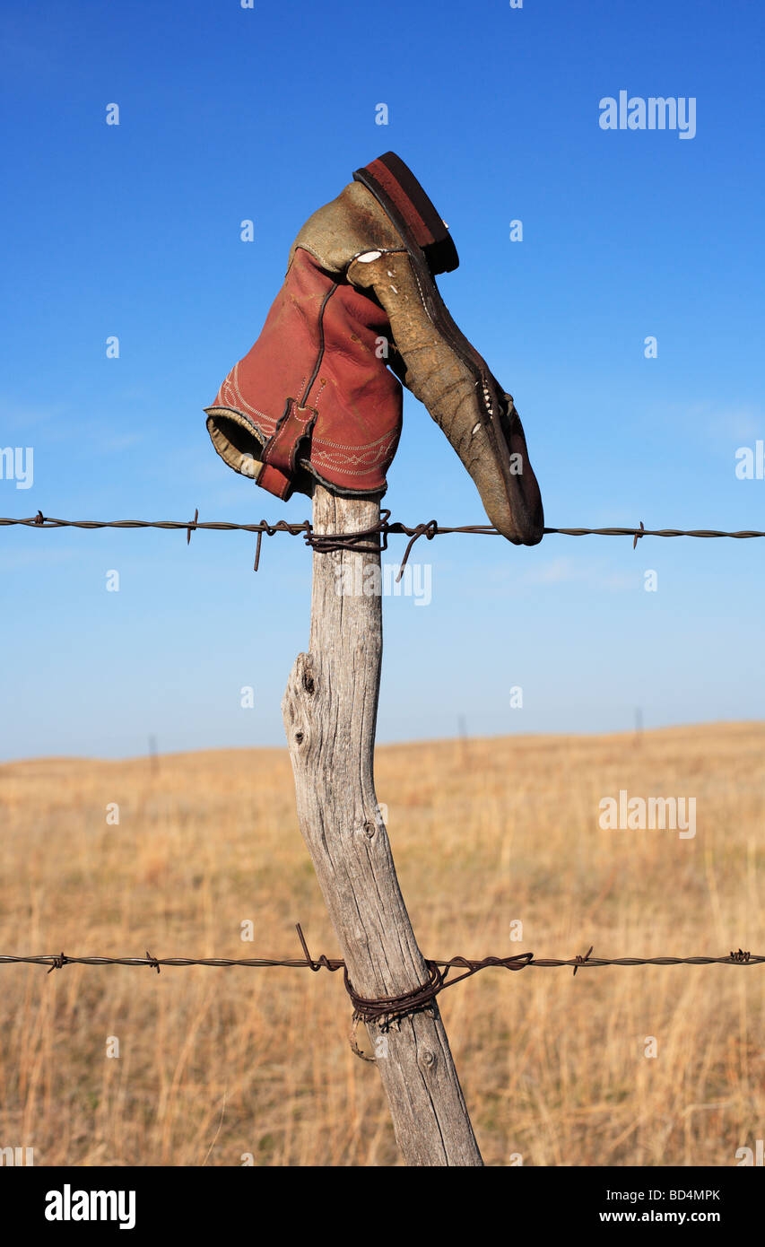 cowboy boot on fence post