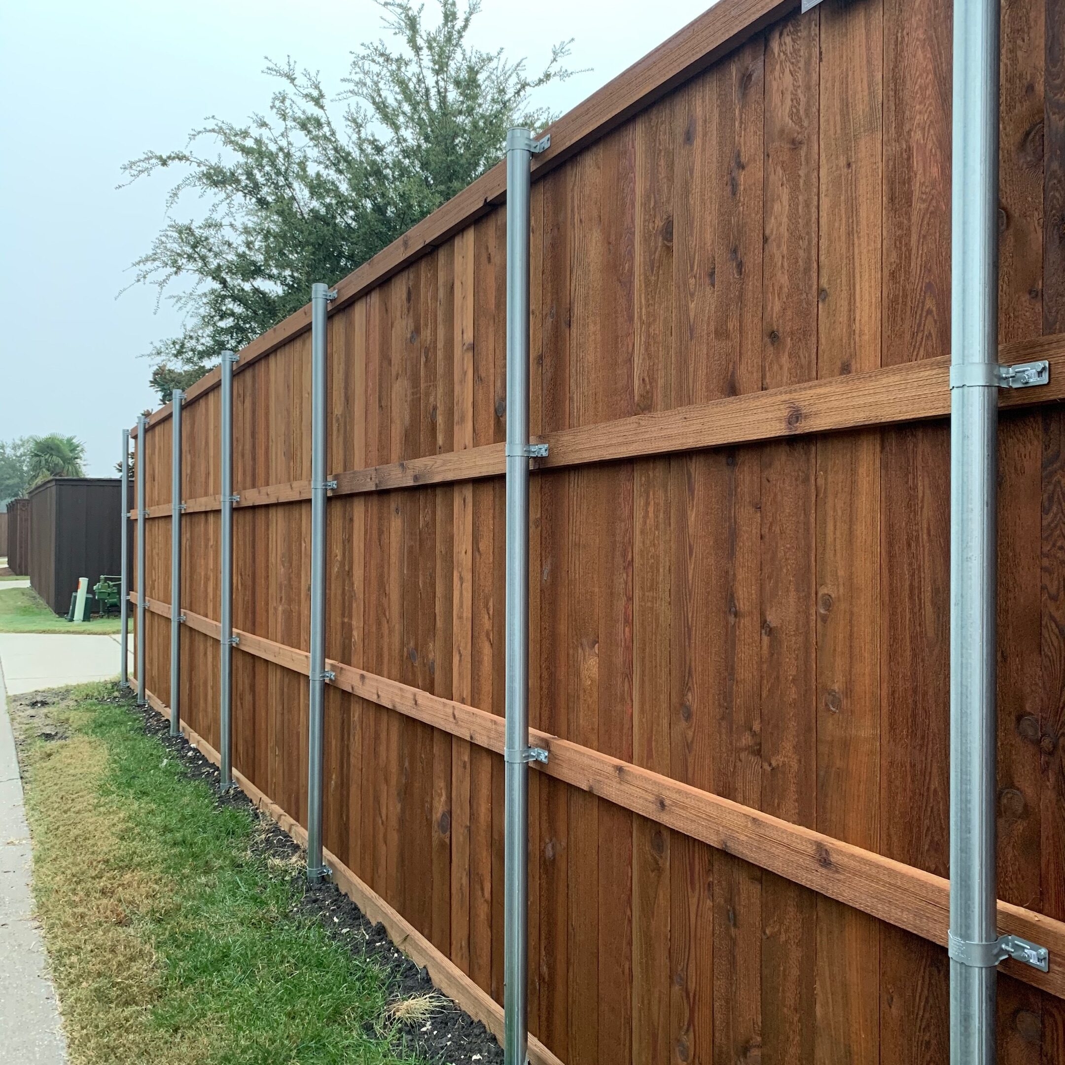 wood privacy fence with metal posts