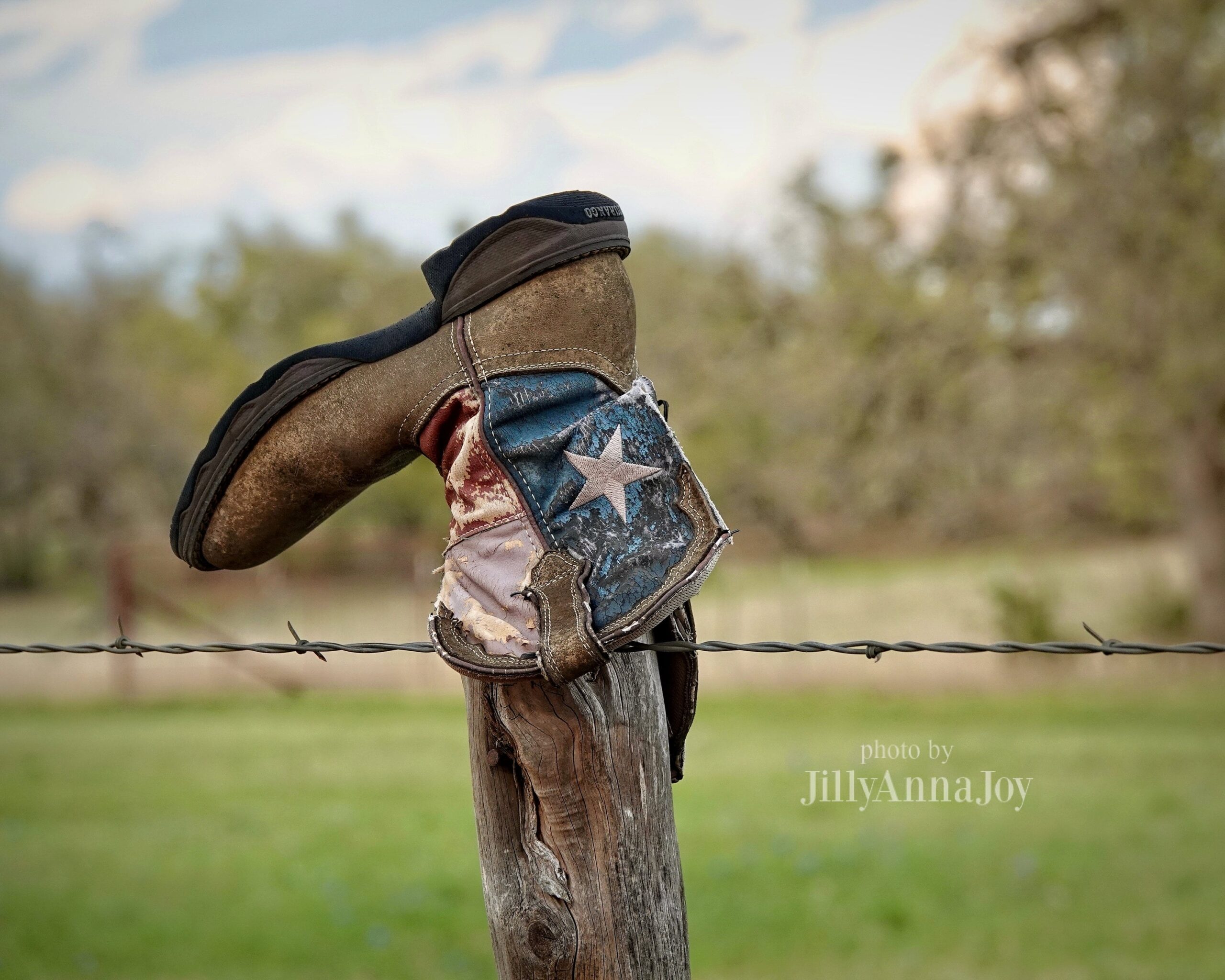 cowboy boots on fence posts