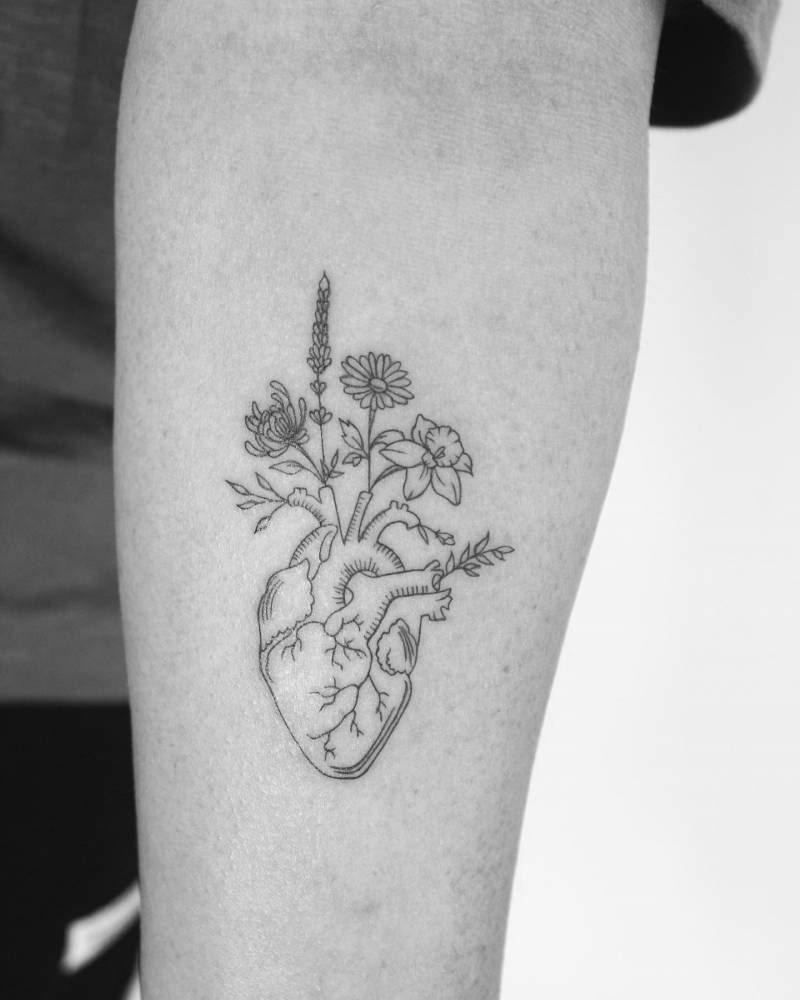 Anatomical Heart With Flowers Tattooed On The Inner
